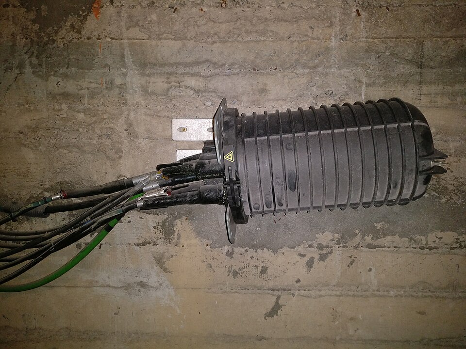 Installed black fiber optic splice closure